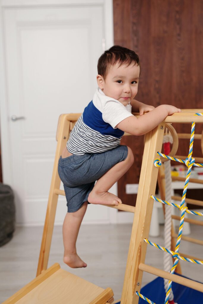 Portrait of Boy Climbing on Toy